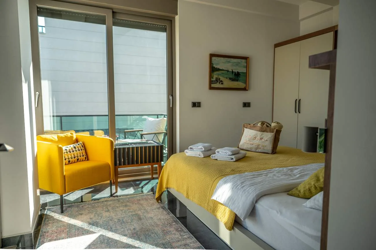 Room Gold with sunny yellow armchair and balcony